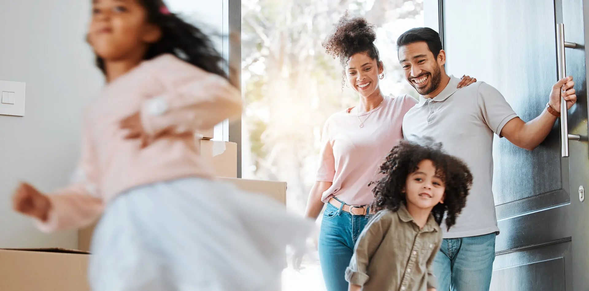 young family walking in the door of new home