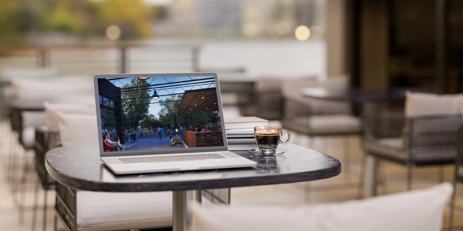A laptop computer in a coffee shop, viewing the COLTON website.